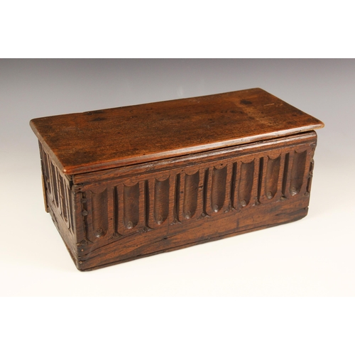 677 - A 17th century and later oak candle box, the later detachable cover above nulled panels to all sides... 