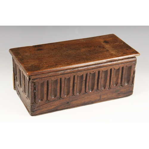 677 - A 17th century and later oak candle box, the later detachable cover above nulled panels to all sides... 