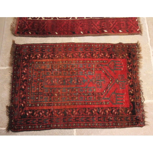 628 - A hand knotted Caucasian woollen prayer rug, in red black and ivory colourways, the stylised leaf pa... 