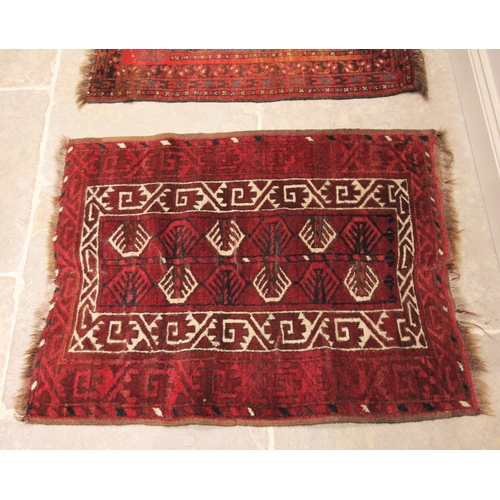 628 - A hand knotted Caucasian woollen prayer rug, in red black and ivory colourways, the stylised leaf pa... 