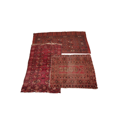 629 - Three Bokhara type rugs, each in red and black colourways with octagonal gulls to the centre field, ... 