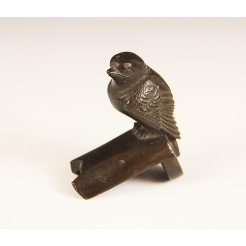 644 - A patinated bronze model of a small garden bird, 20th century, perched on a stylised branch stand, 6... 