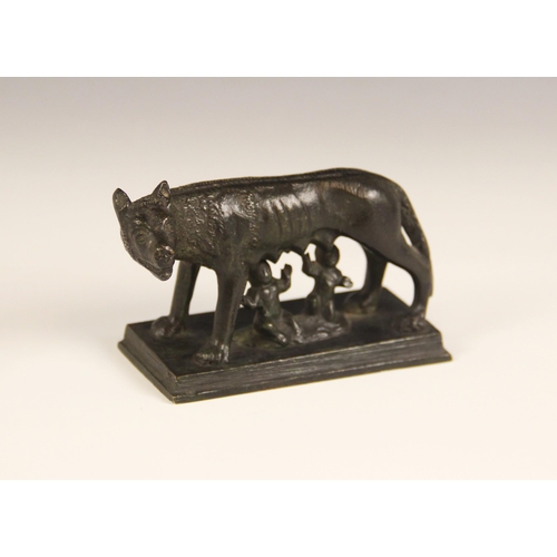 646 - A Grand Tour style patinated bronze group modelled as the she wolf suckling Romulus and Remus, on re... 