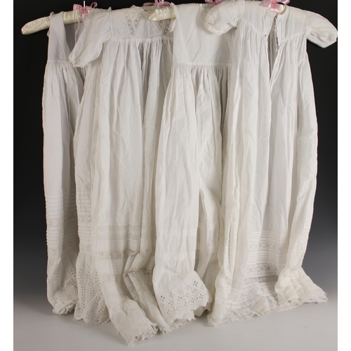 598 - Four early 20th century christening gowns, in fine white cotton, all with broderie anglaise, fine pl... 