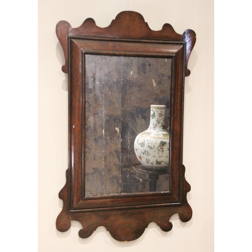 701 - A William and Mary style walnut framed wall mirror, the rectangular mirrored plate within a cushion ... 