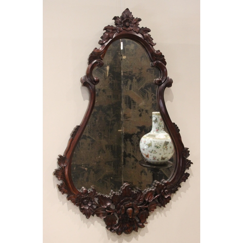 704 - A carved hardwood Florentine style wall mirror, late 20th century, the pear shaped mirrored plate wi... 