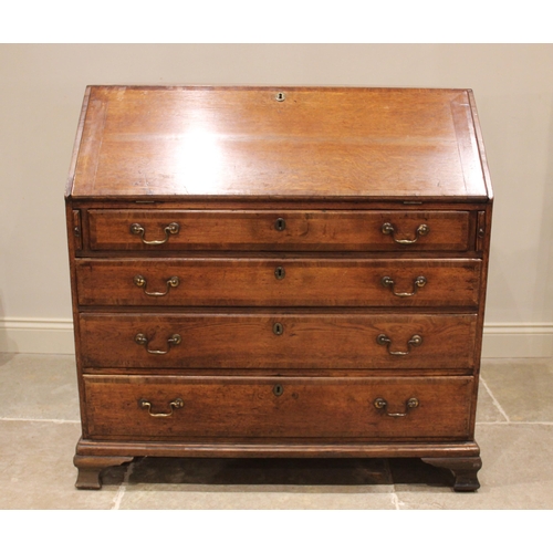 762 - A George III oak and mahogany crossbanded bureau, the fall front opening to a compartmentalised inte... 