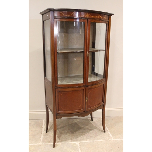 858 - An Edwardian mahogany bowfront display cabinet, the frieze inlaid with an Adam style urn and harebel... 