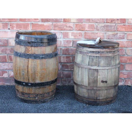 545 - An oak barrel, of typical swelling coopered form with detachable cover, 64cm high, along with a seco... 