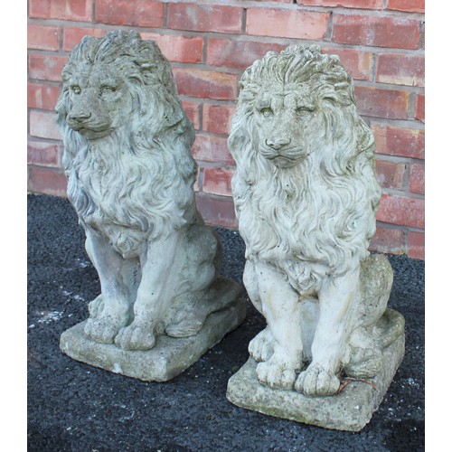 547 - A pair of reconstituted stone lions, each modelled in a seated position upon an integrated rectangul... 