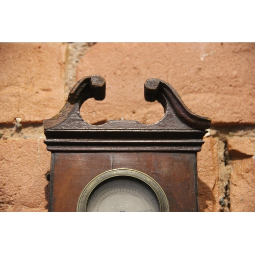 682 - A mid 19th century mahogany wheel barometer by 'Britton Stamford' the swans neck pediment above a si... 