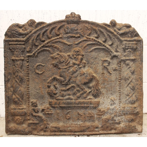 539 - A cast iron fire back, indistinctly bearing the date '1674', of arched form and cast in relief with ... 