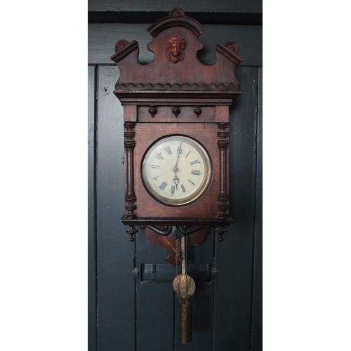 687 - A late 19th century mahogany cased Vienna type wall clock, the rounded pediment above an 18cm painte... 