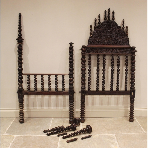 737 - A 17th century style German carved walnut bed frame, the spire shaped headboard with carved scroll d... 