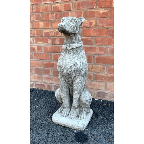 553A - A reconstituted garden figure of an Irish Wolf hound, modelled seated, 74cm high