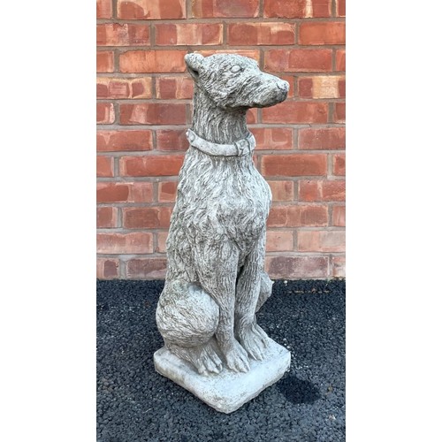 553A - A reconstituted garden figure of an Irish Wolf hound, modelled seated, 74cm high