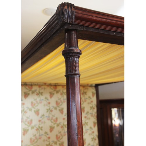 815 - A 19th century mahogany tester bed, the moulded frame and foliate fabric canopy applied with leafy s... 