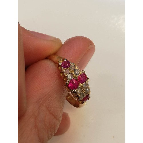 70 - A Victorian ruby and diamond 18ct gold ring, the lozenge shaped head set with two mixed cut rubies, ... 