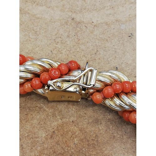 135 - A mid-20th century Italian 18ct gold and coral necklace, the rope twist chain entwined coral beads, ... 