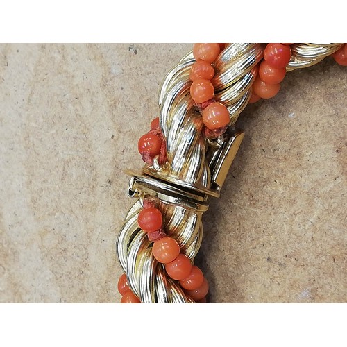 135 - A mid-20th century Italian 18ct gold and coral necklace, the rope twist chain entwined coral beads, ... 