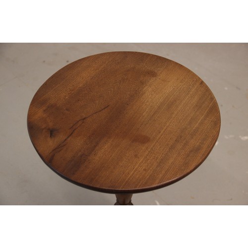 752 - A George III mahogany tripod table, the circular top upon a ring turned baluster column extending to... 