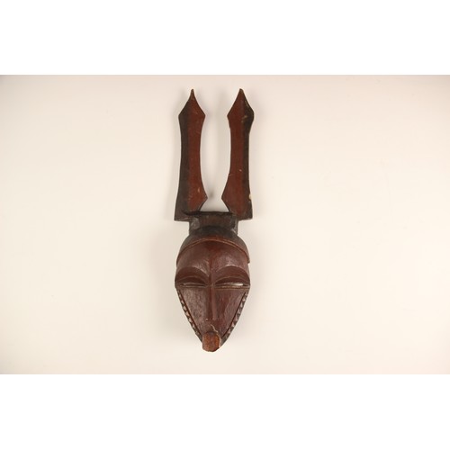 454 - A selection of African works of art, 20th century, to include a Pende mask, 32cm long, a small Hemba... 