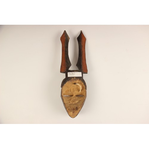 454 - A selection of African works of art, 20th century, to include a Pende mask, 32cm long, a small Hemba... 