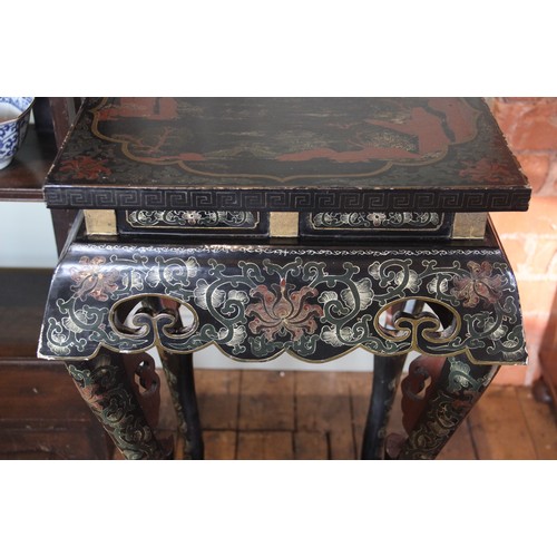 849 - A pair of Chinese lacquered urn stands, the rectangular tops gilt highlighted against a black ground... 