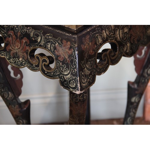 849 - A pair of Chinese lacquered urn stands, the rectangular tops gilt highlighted against a black ground... 