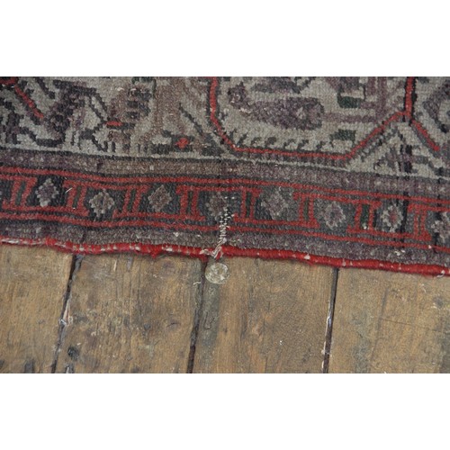 633 - A Persian carpet in red, black and ivory colourways, the central field with repeating leaf motifs, w... 