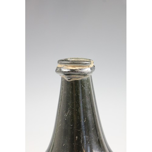 525 - An English 18th century glass wine bottle, of bladder shape and of olive green colour, 17cm high