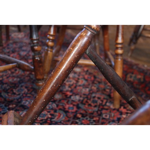 818 - A well matched set of six Victorian elm and ash kitchen chairs, each with a serpentine lath back ove... 