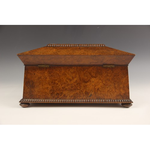 665 - A burr walnut and rosewood sarcophagus shaped tea caddy, early 19th century, the hinged cover inlaid... 