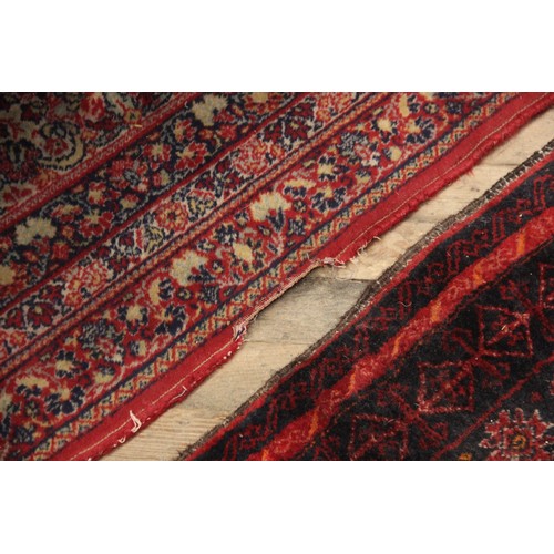 630 - A Persian pattern wool carpet, in red, white and green colourways, the all over foliate design with ... 