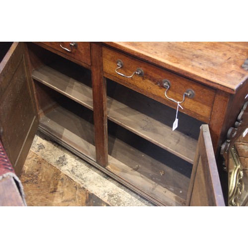 836 - A George III oak country dresser, the rectangular base with two frieze drawers above two panelled cu... 