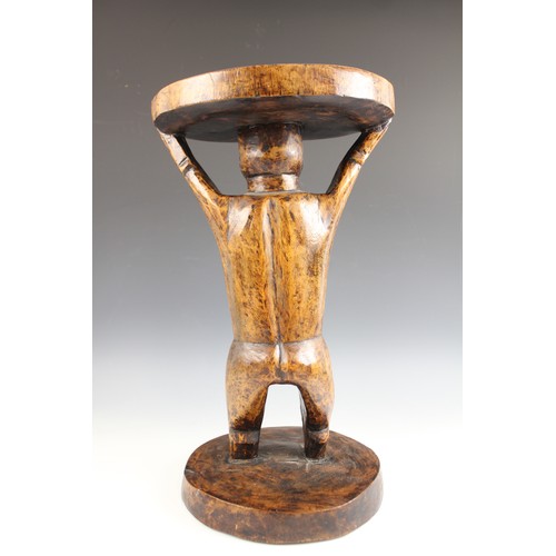 430 - A Southern African Shona Zimbabwe tribal art stool with figure and carved designed to the top, 53cm ... 