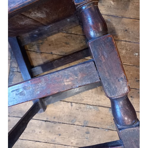 708 - A near pair of early 18th century oak chairs, each with a vase shaped splat over a board seat, raise... 