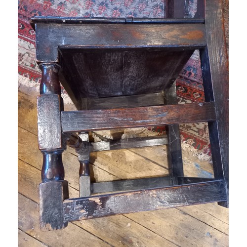 708 - A near pair of early 18th century oak chairs, each with a vase shaped splat over a board seat, raise... 