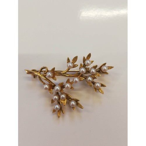 119 - A 9ct gold pearl set foliate spray brooch, designed as a branch with textured leaves and cultured pe... 