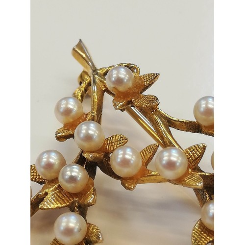 119 - A 9ct gold pearl set foliate spray brooch, designed as a branch with textured leaves and cultured pe... 