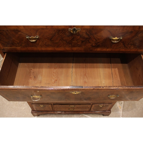 612 - A George I figured walnut chest on chest, early 18th century, the moulded cornice above two short an... 