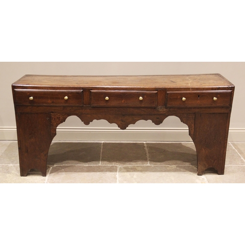 624 - An elm and oak dresser base/work bench, 18th century and later, the plank top over three frieze draw... 