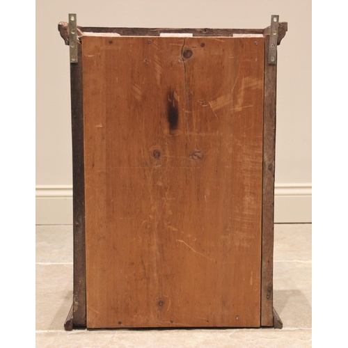 625 - An 18th century oak spice cupboard, the moulded cornice above a single panelled door opening to two ... 