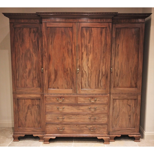 633 - A large Chippendale revival mahogany breakfront wardrobe, early 20th century, the moulded dentil cor... 