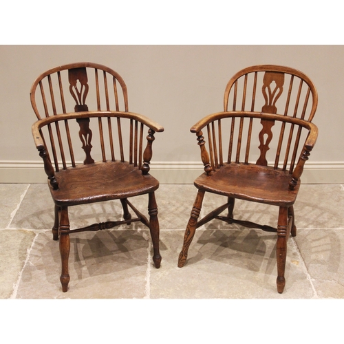 638 - A near pair of ash and elm Windsor elbow chairs, early 19th century, each with a hoop back and pierc... 