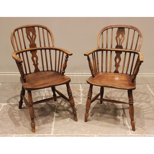 639 - A near pair of ash and elm Windsor elbow chairs, early 19th century, each with a hoop back and pierc... 