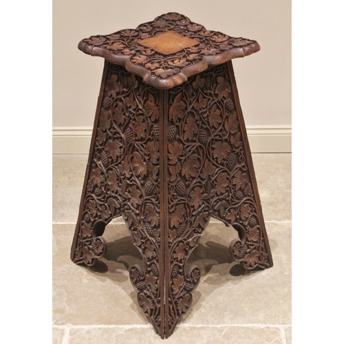 703 - An Arts & Crafts carved walnut plant stand, in the manner of Arthur Simpson, Kendal, early 20th cent... 