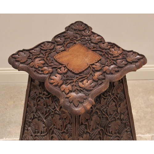 703 - An Arts & Crafts carved walnut plant stand, in the manner of Arthur Simpson, Kendal, early 20th cent... 