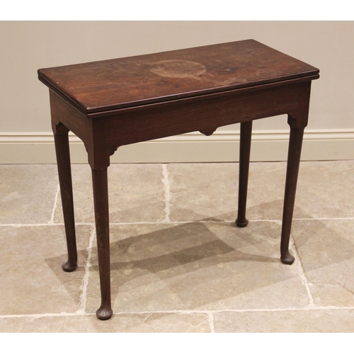 648 - A George III mahogany tea table, the rectangular folding top upon cylindrical tapering legs culminat... 