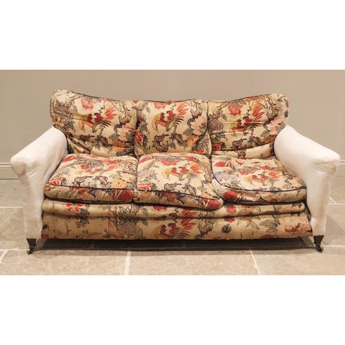 655 - A late Victorian sofa in the manner of Howard & Sons, partially covered in William Morris type fabri... 